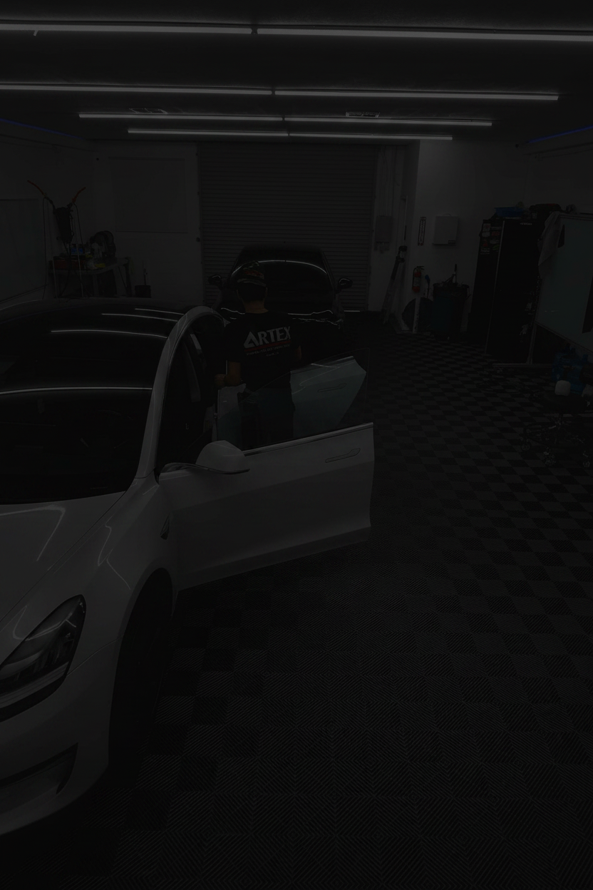 Car interior being worked on in a garage with checkered wall pattern
